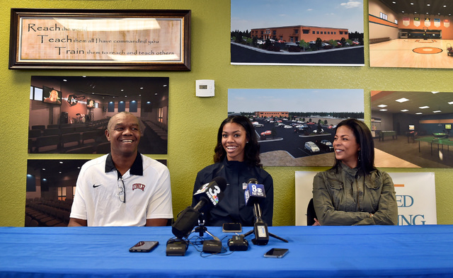 Bishop Gorman high jumper Vashti Cunningham, sits between her father, Randall Cunningham, le ...