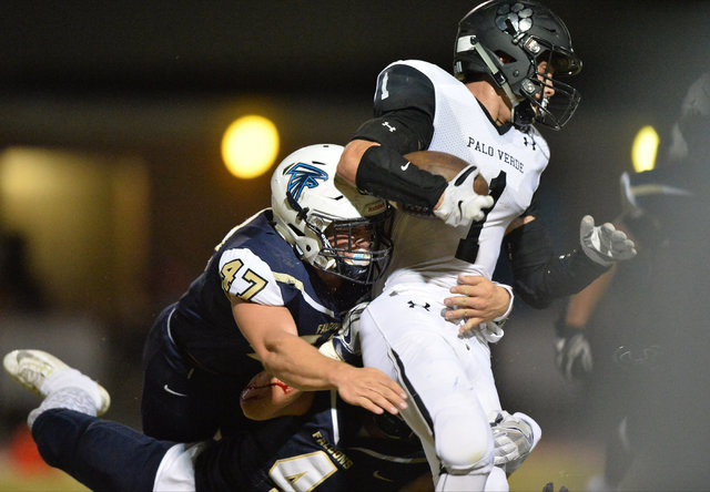 Palo Verde running back Aaron Belshe (1) is brought down by Foothill linebacker Justin Dulap ...