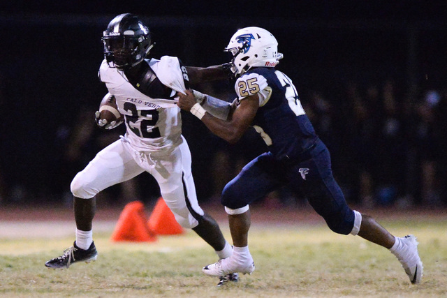 Palo Verde running back Chamber Thomas (22) tries to break a tackle from Foothill cornerback ...