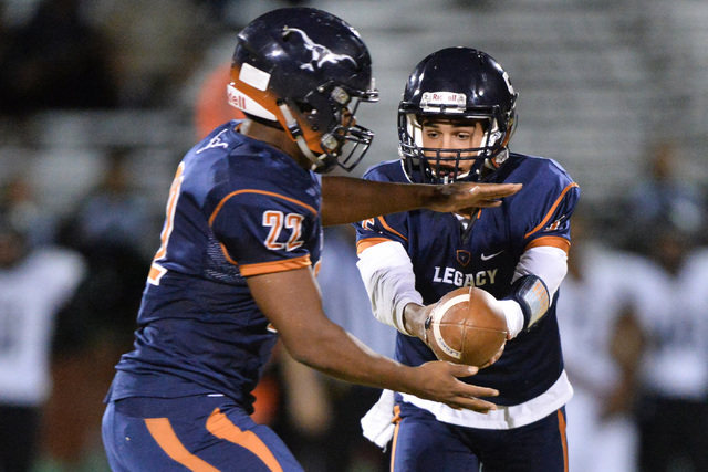 Legacy quarterback Roberto Valenzuela (5) hands the ball off to running back Sam Turner (22) ...