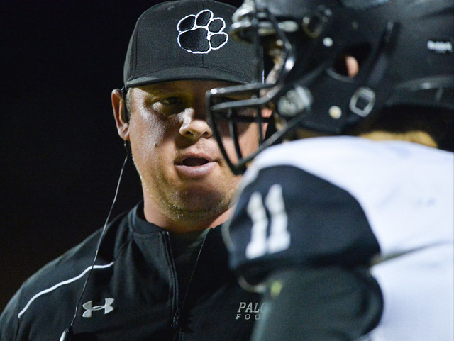 Palo Verde head coach Joe Aznarez talks to quarterback Nick Zuppas (11) during the Legacy Hi ...