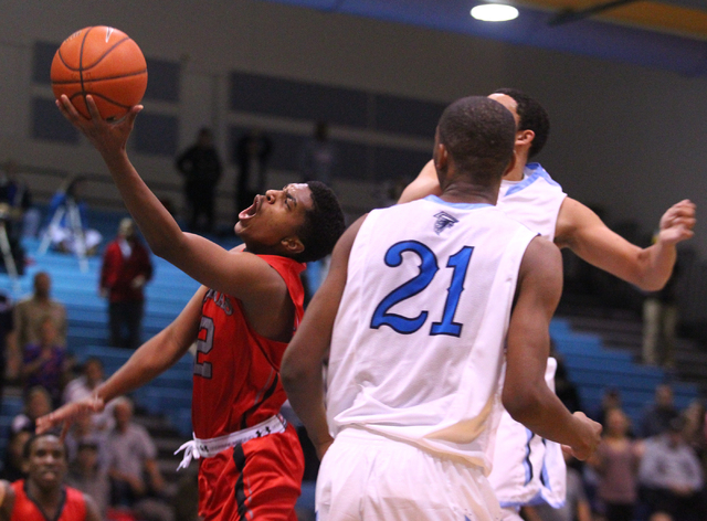 Las Vegas’ Devon Colley (12) drives past Foothill’s Torrance Littles (21) on Tue ...