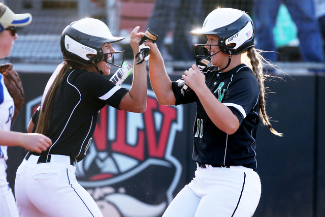 Palo Verde’s Lauren Oxford, right, celebrates crossing the plate with teammate Makall ...