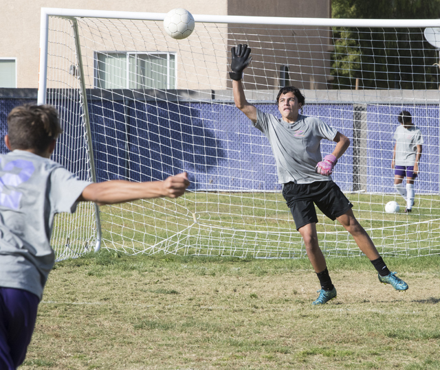 Paolo Sarnataro (23), right, goes up for a ball after Oscar Rodriguez (12) kicks it during s ...