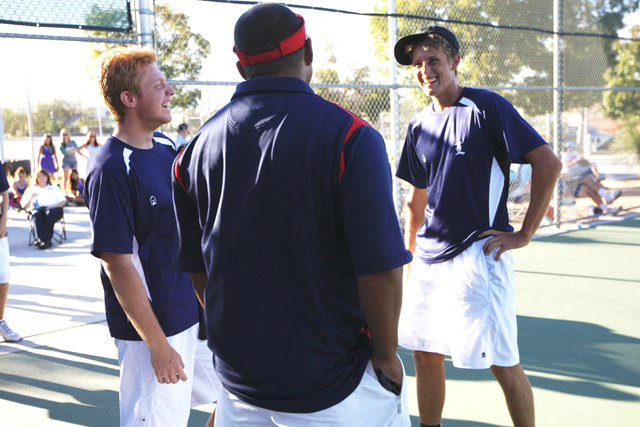 Liberty tennis players Dylan Ihmels, right, and Tristan Hoyle talk with coach Kih Gourrier a ...