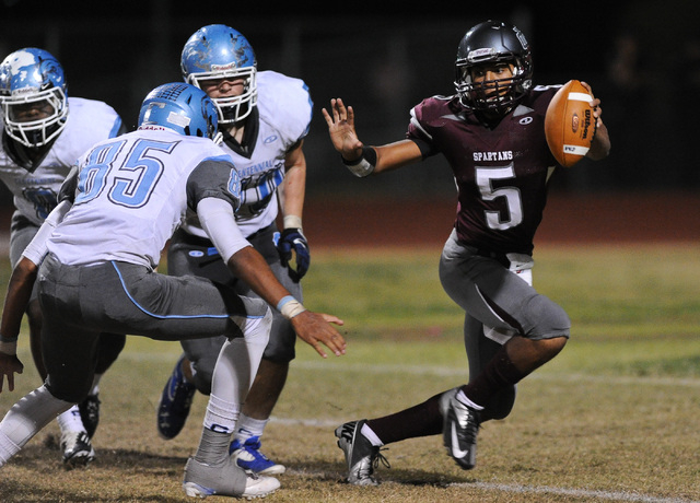 Cimarron’s Derek Morefield (5) looks for running room around Centennial’s Andre ...