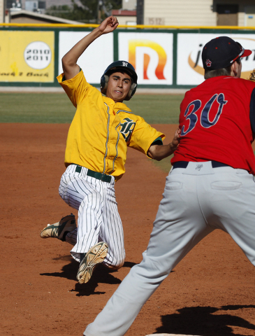 Rancho’s David Camberos slides safely into third base as Coronado’s Caden Spilsb ...