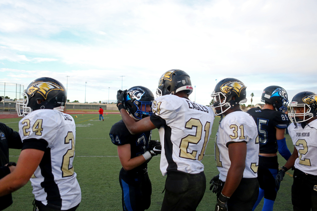 Teammates from Spring Mountain and Pahranagat shake hands after the class 1A state football ...