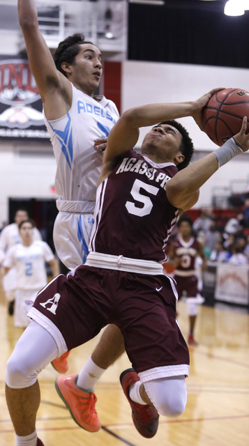 Agassi Prep’s Allen Merritt (5) shoots as Adelson’s Jacob Elharrar (3) blocks du ...