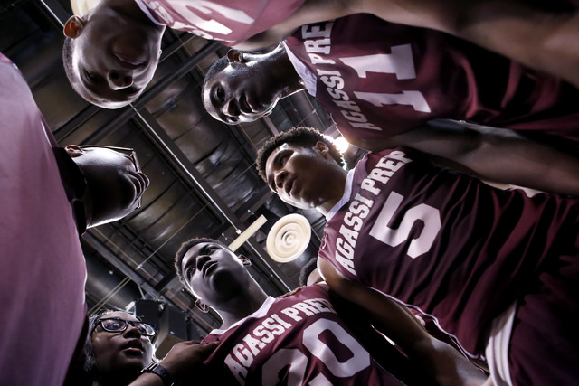 Agassi Prep head coach Trevor Diggs, left, speaks to the players after defeating Adelson Sch ...