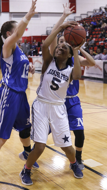 Agassi Prep’s Pa’Shun Minter (5) shoots against Needle’s Paige Murch (12) ...