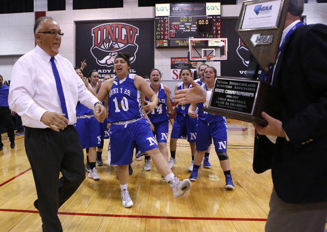 Needle players react as their head coach Manuel Calderon accepts a trophy after winning a Cl ...