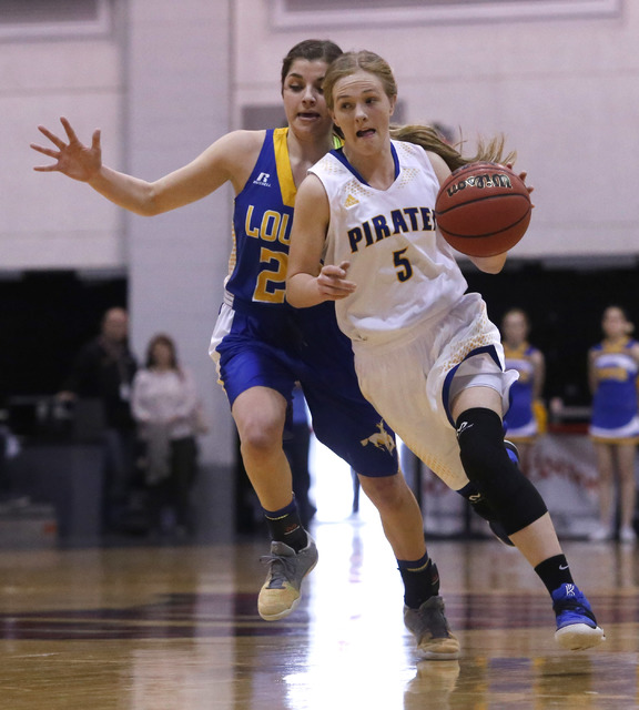 Moapa Valley’s Kinlee Marshall (5) drives the ball pass a Lowry play during the first ...