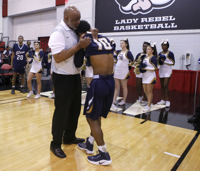 Cheyenne’s Cedric Coleman (10) is comforted in a coaches arms after his team loss to D ...