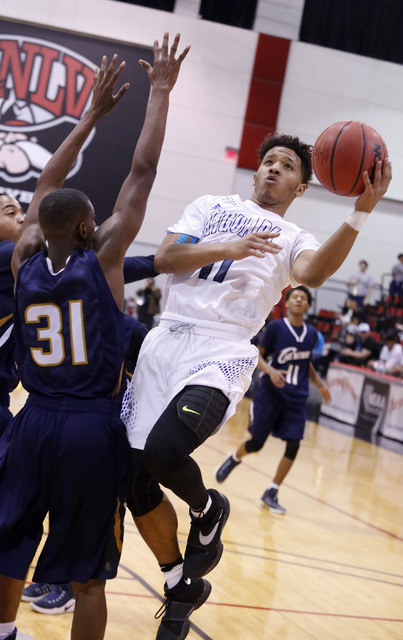 Desert Pines’ Capri Uzan (11) shoots over Cheyenne’s Hahsonie Laushaul (31) duri ...