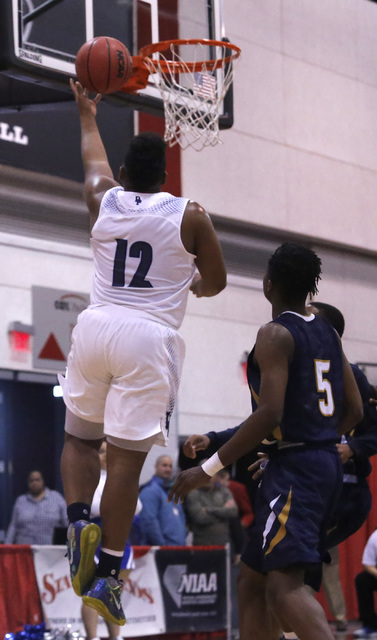 Desert Pine’s Jalen Graves (12) shoots over Cheyenne&quot;s Kavon Williams (5) dur ...