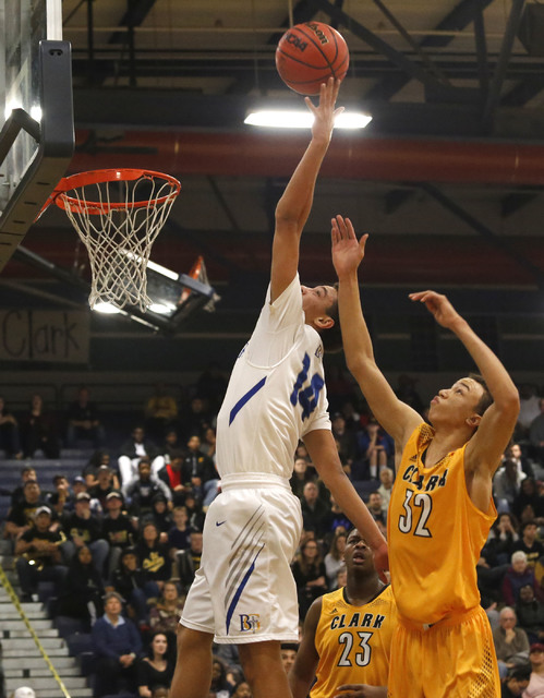 Bishop Gorman’s Saxton Howard (14) grabs a rebound over Clark’s Ian Alexander (3 ...