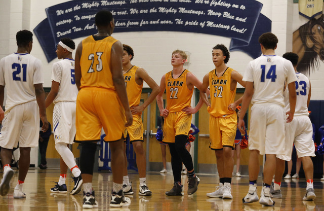 Clark players react during the second half of a Class 4A Sunset Region championship boys bas ...