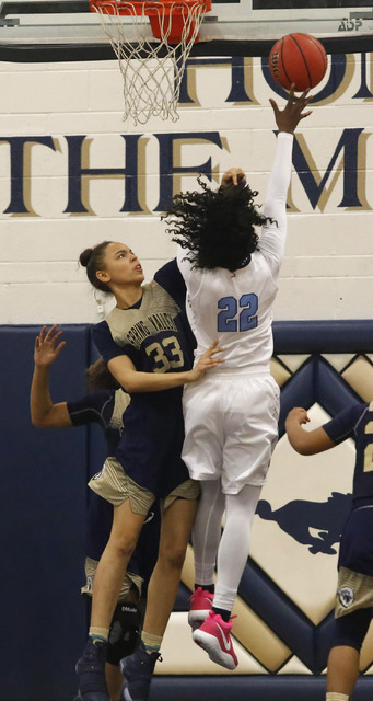 Centennial’s Eboni Walker (22) shoots over Spring Valley’s Alexus Quaadman (33) ...