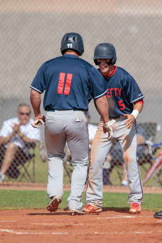 Liberty High School senior Preston Pavlica (11) left, is greeted at the plate by his teammat ...