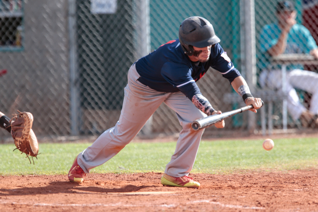 Liberty High School senior Lucas Bogues (1) reaches out to bunt the ball during a baseball g ...