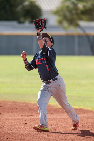 Liberty High School senior Lucas Bogues (1) makes ready for an infield fly ball during a bas ...