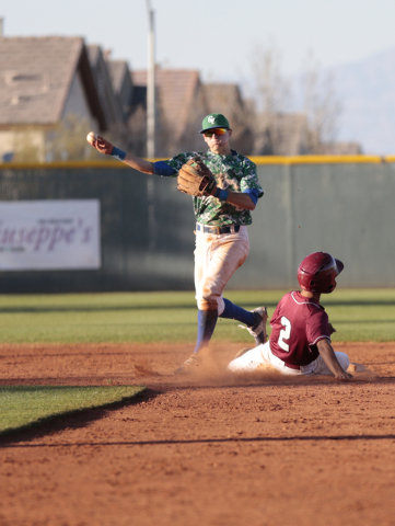 Green Valley senior Jarod Penniman (4) throws towards first base after getting Desert Oasis ...