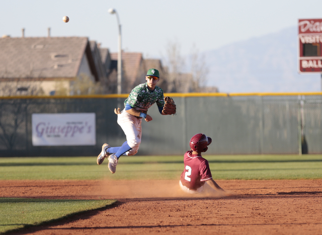 Green Valley senior Jarod Penniman (4) throws towards first base after getting Desert Oasis ...