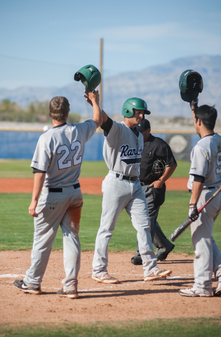 Rancho senior Jose Verdugo, center, is congratulated by teammates from left, Dylan Pletsch a ...