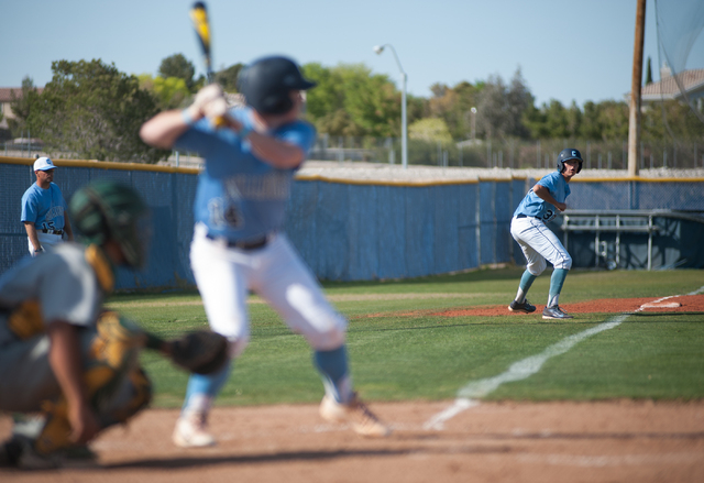 Centennial junior Travis Stevens, right, takes a lead from third base as batter Josh McKibbi ...