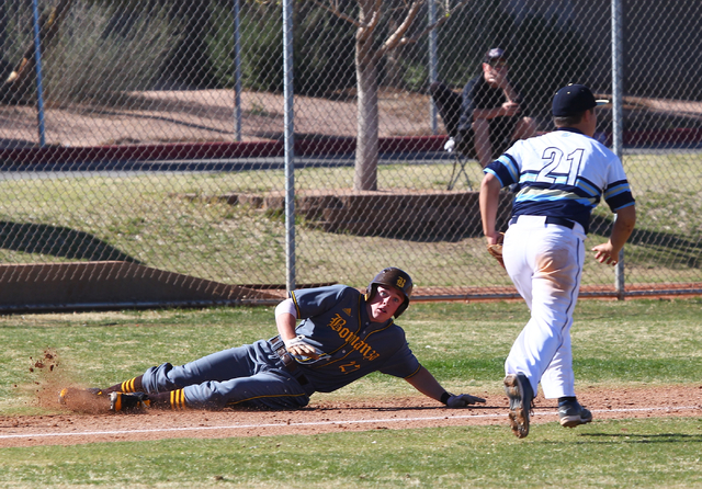 Bonanza’s Chris Dunn (22) slides safely into third base as Foothill’s Kaelii Mar ...