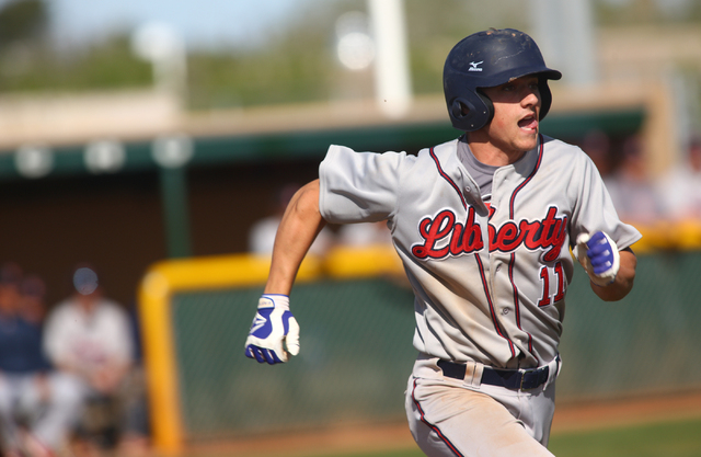 Liberty’s Preston Pavlica (11) runs to first base in Saturday’s game against Ran ...