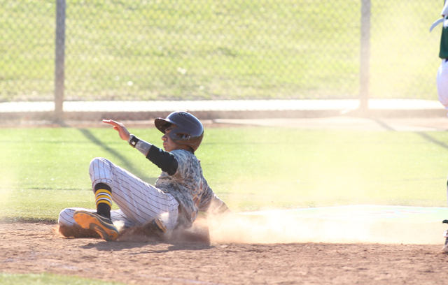 Bonanza’s Cruz Nevarez (2) slides into home against Green Valley on Friday. (Chase Ste ...