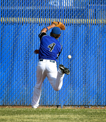 Basic’s Logan Green misses a fly ball in center field during a high school baseball ga ...