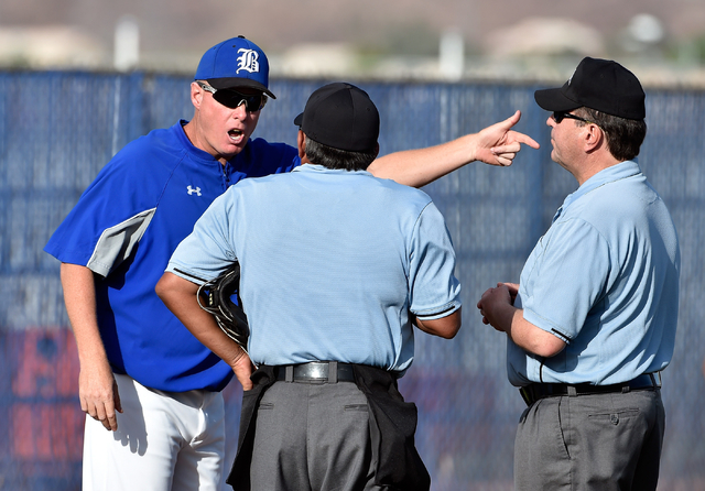 Basic head coach Scott Baker, left, questions the umpire’s call during a high school b ...