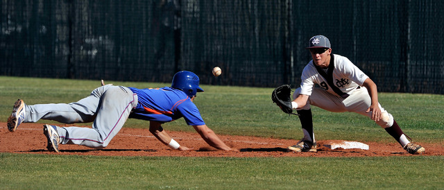 Bishop Gorman’s Cole Krzmarzick dives back to first base during an attempted pickoff w ...