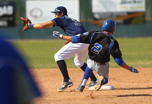 Basic’s Cory Wills (2) slides into second base as Foothill’s Nick Cardinale wait ...