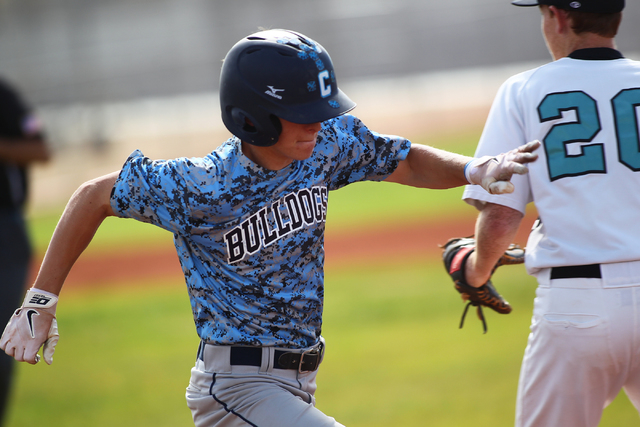 Centennial’s Ricky Koplow reaches first base safely after a bunt single in the second ...