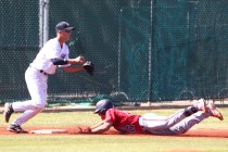 Liberty’s Josh McCollum slides safely into third base as Spring Valley’s Bryce B ...