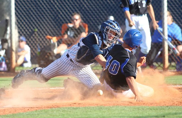 Basic’s Isaac Perez (40) slides into home plate as Chatsworth catcher Jake Ryan loses ...