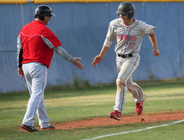 Coronado’s Nate Ruiz, right, prepares to slap hands with assistant coach Rich Ebarb af ...