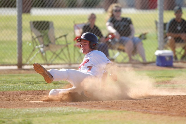 Liberty’s Trevor Mullaney (7) slides home for a run against Silverado in their basebal ...