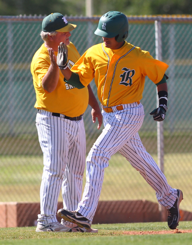 Rancho’s Jose Verdugo, right, high-fives coach Tom Pletsch following his two-run home ...