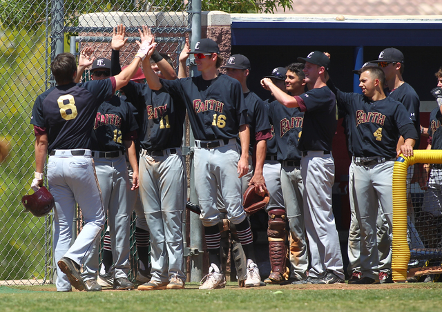 Faith Lutheran’s Erich Uelman (8) celebrates his home run with teammates in the third ...