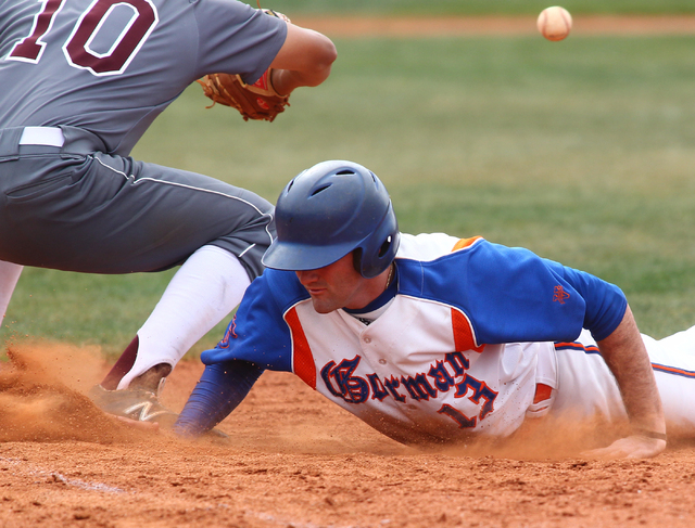 Bishop Gorman’s Bronson Bowe (13) dives back to first as Cimarron-Memorial’s Lui ...