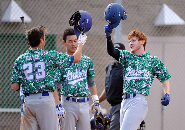 Green Valley’s Keaton Smith (4) celebrates with teammates Anthony Hatch (23) and Blake ...