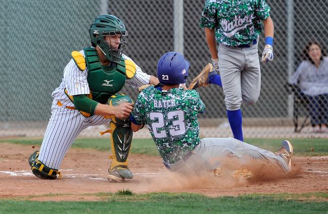 Green Valley’s Anthony Hatch (23) is tagged out at home plate by Rancho catcher Zach B ...