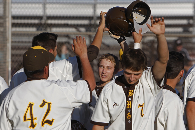 Bonanza outfielder Levi Klump, center, is congratulated after scoring on a sacrifice fly dur ...