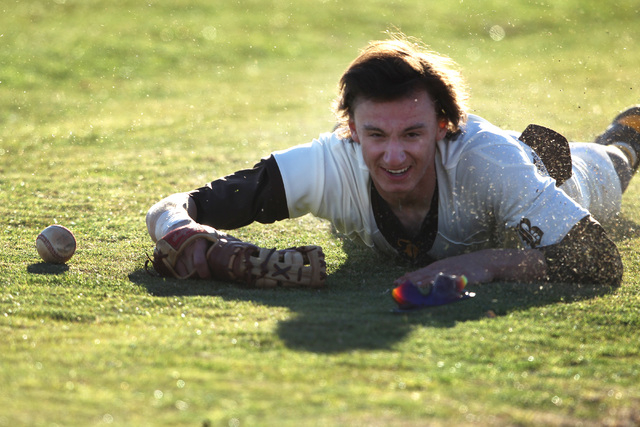 Bonanza outfielder Jonathan Massey hits the grass after coming up short missing a pop foul d ...