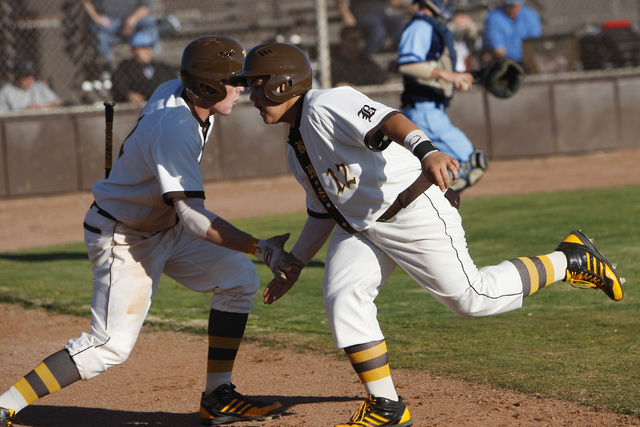 Bonanza’s Jay DeSoto, right is congratulated by Chris Dunn after scoring a run during ...